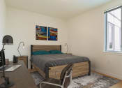 Thumbnail 57 of 57 - a bedroom with a bed and desk in a 555 waverly unit at Jefferson Yards, Tacoma, WA