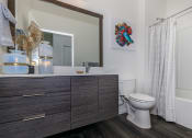 Thumbnail 19 of 24 - a bathroom with a toilet and a sink at Napoleon Apartments, Tacoma