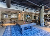 Thumbnail 3 of 24 - a pool table sits in the middle of a room with a bar in the background at Napoleon Apartments, Tacoma, 98402