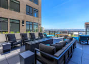 Thumbnail 7 of 24 - an apartment patio with a pool and lounge chairs at Napoleon Apartments, Washington, 98402