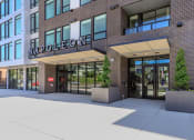 Thumbnail 6 of 24 - a brick building with a large glass door at Napoleon Apartments, Washington