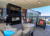 Thumbnail 11 of 24 - a living room with couches chairs and a fireplace at Napoleon Apartments, Tacoma Washington