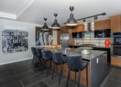 Thumbnail 18 of 24 - a kitchen with a large center island with a breakfast bar at Napoleon Apartments, Tacoma Washington