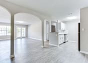 Thumbnail 9 of 14 - A spacious living room with a kitchen area in the background at Ballantyne Commons of Stockbridge Apartments, GA, 30281