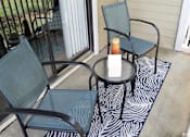 Thumbnail 14 of 20 - A candle is lit on a table outside at The Madison Apartments and Townhomes, Lawrenceville