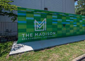 Thumbnail 15 of 20 - A green and blue sign for The Madison Apartments & Townhomes at The Madison Apartments and Townhomes, Lawrenceville, GA, 30044
