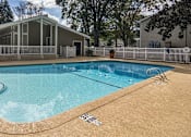 Thumbnail 17 of 20 - A small pool with a white fence around it at The Madison Apartments and Townhomes, Lawrenceville, 30044