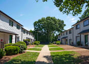 Thumbnail 3 of 20 - A row of houses with a pathway in the middle at The Madison Apartments and Townhomes, Georgia 30044