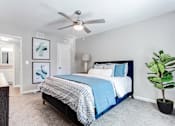 Thumbnail 11 of 27 - A bedroom with a bed, a ceiling fan, and a plant at Barcelo at East Cobb Apartments, GA, 30067