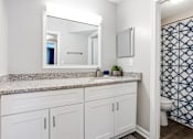 Thumbnail 12 of 27 - A bathroom with a granite countertop at Barcelo at East Cobb Apartments, Georgia, 30067