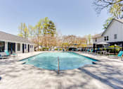 Thumbnail 21 of 27 - A large outdoor swimming pool surrounded by a tiled patio and lounge chairs at Barcelo at East Cobb Apartments, Marietta, GA, 30067