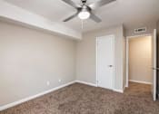 Thumbnail 14 of 60 - an empty room with a ceiling fan and a door at Cleo Apartments, Athens, 35611