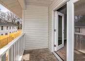 Thumbnail 32 of 60 - a balcony with a door to a white house at Cleo Apartments, Athens, AL