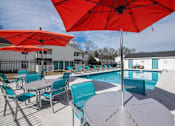 Thumbnail 36 of 60 - a pool with chairs and umbrellas around it at Cleo Apartments, Athens, Alabama