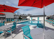 Thumbnail 37 of 60 - a swimming pool with tables and chairs and umbrellas at Cleo Apartments, Alabama, 35611