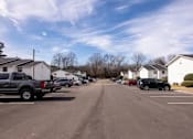 Thumbnail 50 of 60 - a city street with cars parked in a parking lot at Cleo Apartments, Alabama, 35611