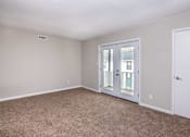 Thumbnail 7 of 60 - an empty living room with white walls and white doors at Cleo Apartments, Athens, AL