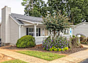 Thumbnail 12 of 14 - A small house with a well-kept front yard at Overlook Club Apartments, Cummings, GA, 30040