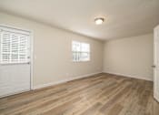 Thumbnail 3 of 14 - A room with wooden flooring and a window with blinds at Overlook Club Apartments, Cummings, GA