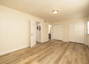 Thumbnail 5 of 14 - A room with wooden floors and white walls at Overlook Club Apartments, Cummings, GA, 30040