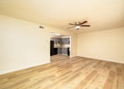 Thumbnail 6 of 14 - A room with a ceiling fan and wooden flooring at Overlook Club Apartments, Cummings, Georgia