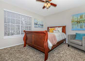 Thumbnail 7 of 16 - a bedroom with a bed and a ceiling fan at The Davis Apartments, Alabama, 35816