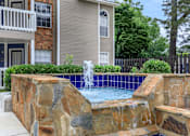 Thumbnail 6 of 16 - a pool with a fountain in front of a house at The Davis Apartments, Alabama  