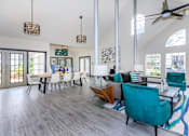 Thumbnail 10 of 16 - a living room and dining room with a table and chairs at The Davis Apartments, Huntsville, 35816  
