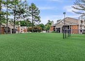 Thumbnail 2 of 16 - community yard with fence and apartment buildings at The Davis Apartments, Huntsville, AL  