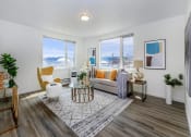 Thumbnail 9 of 57 - a living room with a couch and three windows at Jefferson Yards, Tacoma, 98402