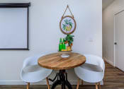 Thumbnail 45 of 57 - a dining room with a table and four chairs at Jefferson Yards, Tacoma Washington