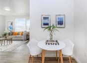 Thumbnail 44 of 57 - a dining area with a table and chairs and a couch in the background at Jefferson Yards, Tacoma, 98402