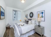 Thumbnail 41 of 57 - a bedroom with a bed and a dresser next to it at Jefferson Yards, Washington, 98402