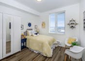Thumbnail 35 of 57 - a bedroom with a bed next to a window  at Jefferson Yards, Tacoma, WA 98402