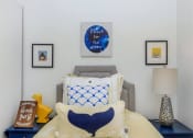 Thumbnail 34 of 57 - a bedroom with a bed and a nightstand with a lamp on it at Jefferson Yards, Washington, 98402