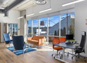 Thumbnail 29 of 57 - a room with a large window and a desk with a computer at Jefferson Yards, Tacoma, WA