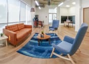 Thumbnail 27 of 57 - a living room with blue chairs and a brown couch at Jefferson Yards, Washington, 98402