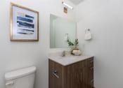 Thumbnail 22 of 57 - a bathroom with a toilet sink and mirror at Jefferson Yards, Tacoma, WA