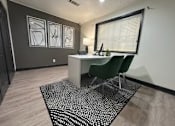 Thumbnail 4 of 22 - A room with a desk and a chair.