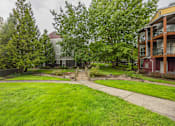 Thumbnail 36 of 48 - A green lawn in front of a building.