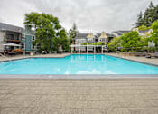 Thumbnail 41 of 48 - A swimming pool surrounded by trees and houses.