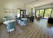 Thumbnail 6 of 28 - a room with hardwood floors and large windows at Commons on the Tualatin River, Tualatin