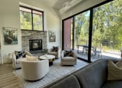 Thumbnail 8 of 28 - a living room with couches chairs and a fireplace at Commons on the Tualatin River, Tualatin, Oregon