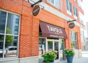Thumbnail 9 of 10 - a brick building with a brown awning and a sign that says taylor restaurant and