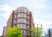 Thumbnail 4 of 10 - a red brick building with white trimmed windows