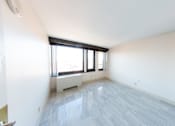 Thumbnail 20 of 21 - A room with a window and a radiator on the wall.