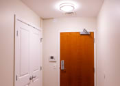 Thumbnail 12 of 17 - a door in a hallway with a light above it