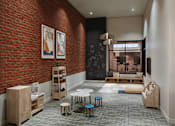 Thumbnail 3 of 27 - A room with a red brick wall and a black chalkboard with a white bench and a table.