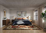 Thumbnail 7 of 27 - A bedroom with a large bed and a rug on the floor.