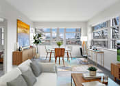 Thumbnail 8 of 28 - a living room with a white couch and a table and a window